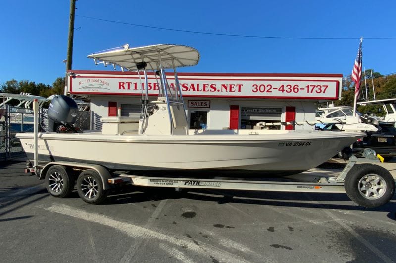 2013 Pathfinder 2200 TRS boat on trailer at dealership, sunny day.