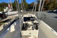 2013 Pathfinder 2200 TRS boat console with steering wheel and controls, parked outdoors.