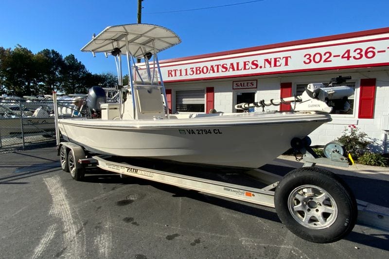 2013 Pathfinder 2200 TRS boat on trailer at dealership, sunny day.