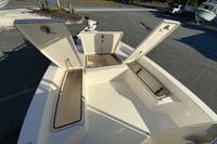 2013 Pathfinder 2200 TRS boat with open storage compartments on deck.