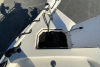 2013 Pathfinder 2200 TRS boat deck with open storage compartment and trolling motor.