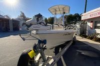 2013 Pathfinder 2200 TRS boat on trailer, equipped with Garmin technology, under sunny sky.