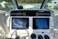 Control panel of a 2017 Everglades 253 Center Console boat with navigation screens.