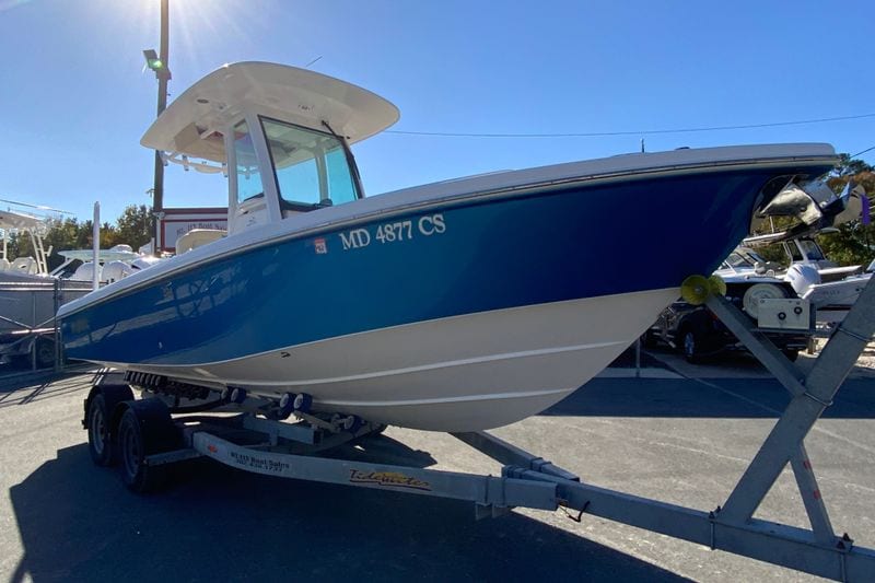 2017 Everglades 253 Center Console boat on trailer, blue and white design.