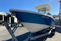 2017 Everglades 253 Center Console boat on trailer, blue hull, sunny day.