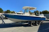 2017 Everglades 253 Center Console boat on trailer, blue hull, parked outdoors.