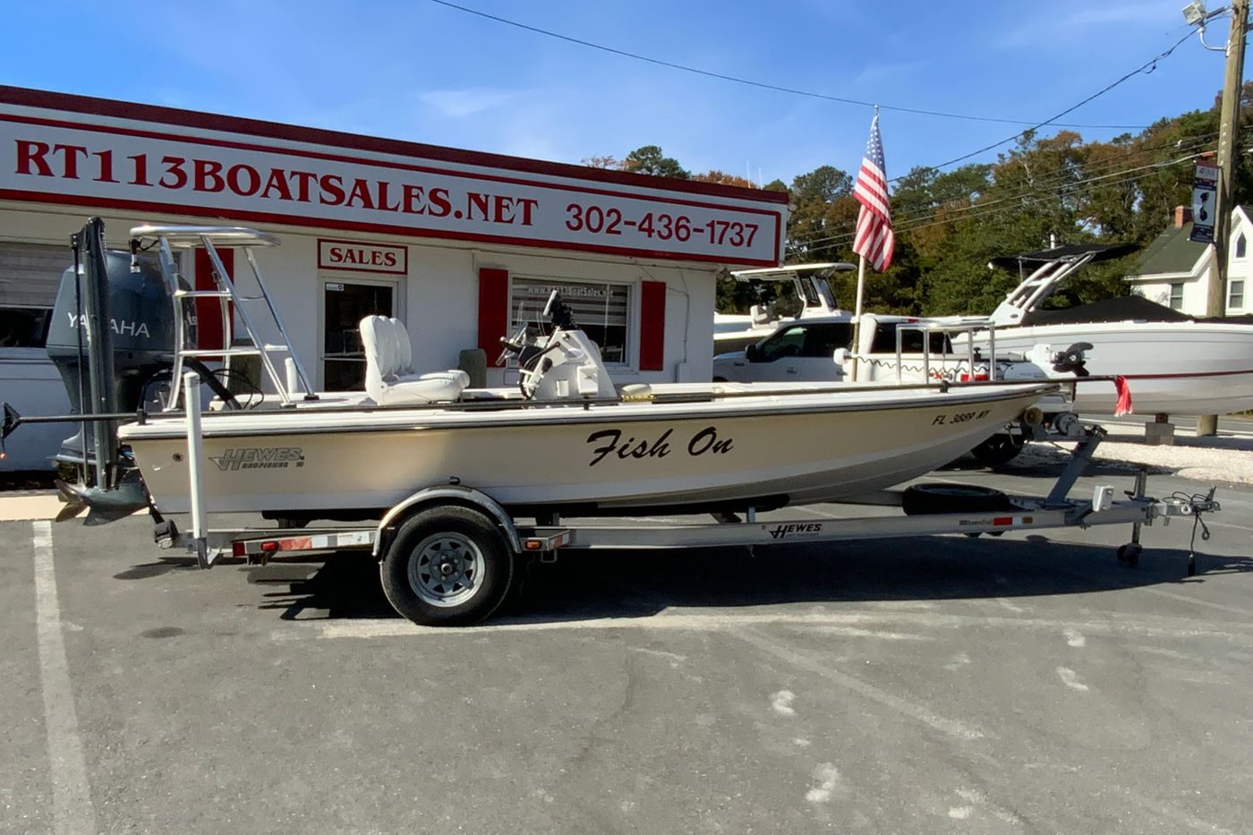 2009 Hewes Redfisher 18 boat on trailer at dealership, ready for sale.