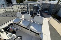 2009 Hewes Redfisher 18 boat with white seating and Yamaha 150 engine.