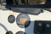 Dashboard of a 2009 Hewes Redfisher 18 boat with Yamaha tachometer and lift plate gauge.