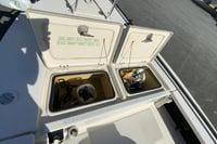 2009 Hewes Redfisher 18 boat storage compartments with various items inside.