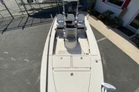 2009 Hewes Redfisher 18 boat with seating and storage, parked on pavement.