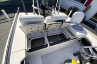 2009 Hewes Redfisher 18 boat interior with open storage compartments and seating.