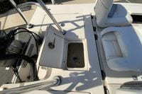 2009 Hewes Redfisher 18 boat interior with open storage compartment and seating.