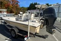 2009 Hewes Redfisher 18 boat with Yamaha engine on trailer, parked outdoors.