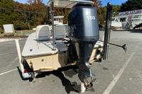 2009 Hewes Redfisher 18 boat with Yamaha 150 outboard motor, parked outdoors.