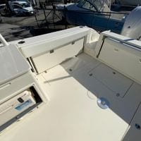 2025 Cobia 280 Dual Console boat interior with storage compartments and seating area.