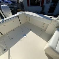 2025 Cobia 280 Dual Console boat interior with storage compartments and seating.