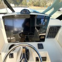 2025 Cobia 280 Dual Console dashboard with steering wheel, Garmin display, and control panel.