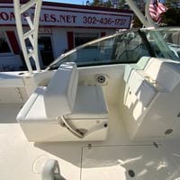 2025 Cobia 280 Dual Console boat interior with white seating and dashboard.