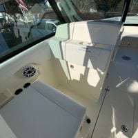 2025 Cobia 280 Dual Console interior with seating and speaker, showcasing luxury design.