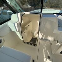 2025 Cobia 280 Dual Console boat interior with open restroom door.