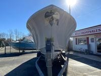 2025 Cobia 280 Dual Console boat on trailer at dealership.