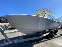 2025 Cobia 280 Dual Console boat on trailer, displayed outdoors.