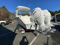 2025 Cobia 280 Dual Console boat with twin Yamaha engines on a trailer.