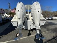 2025 Cobia 280 Dual Console with twin outboard engines, parked outdoors.