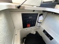 Control panel and fire extinguisher in 2026 Cobalt R4 OB boat interior.