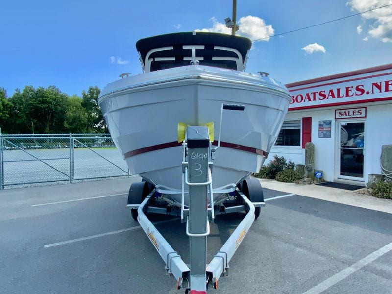 2026 Cobalt R4 OB boat on trailer at dealership, clear sky background.