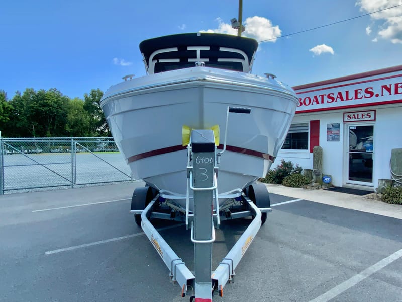 2026 Cobalt R4 OB boat on trailer at dealership, clear sky background.