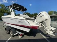 2026 Cobalt R4 OB boat with Yamaha engine on trailer, parked outdoors.