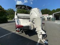 2026 Cobalt R4 OB boat with Yamaha 300 V6 engine in a parking lot.