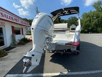 2026 Cobalt R4 OB boat with outboard motor, parked outside a sales building.