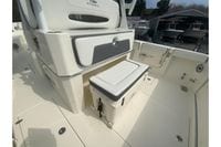 2026 Cobia 305 Center Console boat interior with seating and storage features.