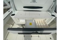 2026 Cobia 305 Center Console boat interior with storage compartments and cup holders.