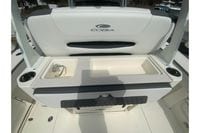 2026 Cobia 305 Center Console boat interior with sink and storage compartments.