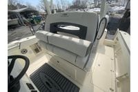 2026 Cobia 305 Center Console boat interior with cushioned seating and deck view.