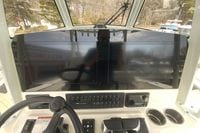 2026 Cobia 305 Center Console dashboard with dual Garmin displays and control panel.