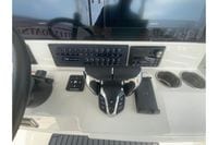 2026 Cobia 305 Center Console dashboard with controls, Garmin screens, and cup holders.