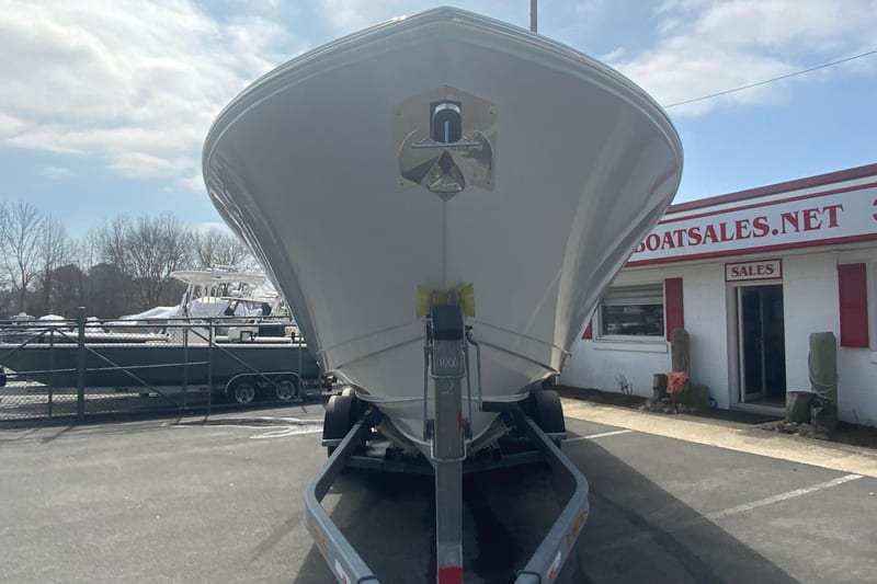 2026 Cobia 305 Center Console boat on trailer at dealership.