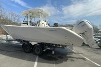 2026 Cobia 305 Center Console boat on trailer with Yamaha engine, parked outdoors.