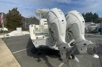 2026 Cobia 305 Center Console with twin Yamaha 350 engines in a parking lot.