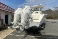 2026 Cobia 305 Center Console boat with dual Yamaha engines on a trailer.