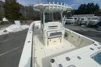 2026 Cobia 305 Center Console boat at dealership, showcasing spacious deck and seating.