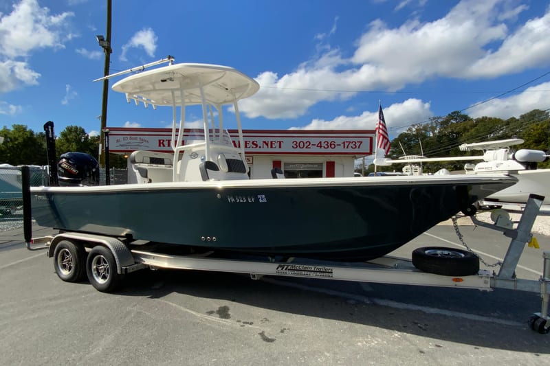 2022 Tidewater 2300 Carolina Bay boat on trailer at dealership, under blue sky.