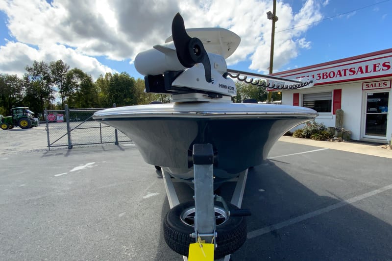 2022 Tidewater 2300 Carolina Bay boat on trailer at dealership, under cloudy sky.