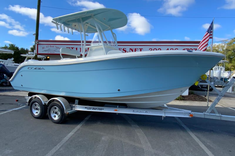 2026 Cobia 220 Center Console boat on trailer at dealership.