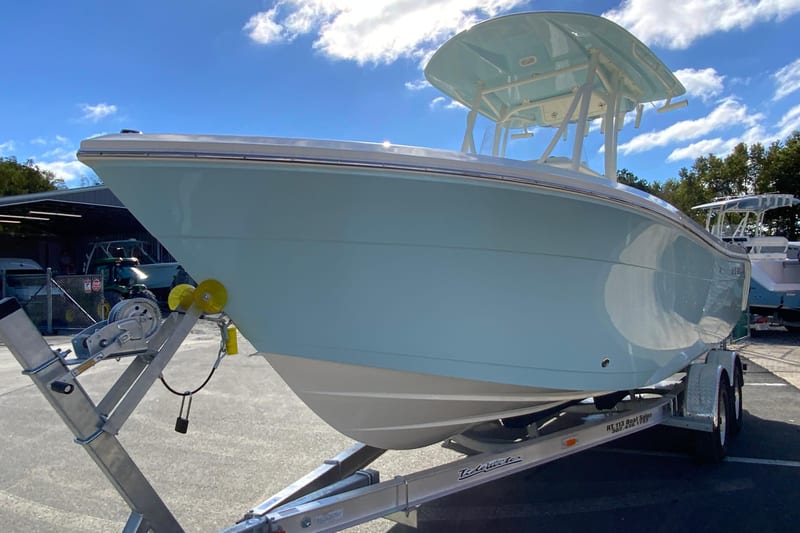 2026 Cobia 220 Center Console boat on trailer under blue sky.